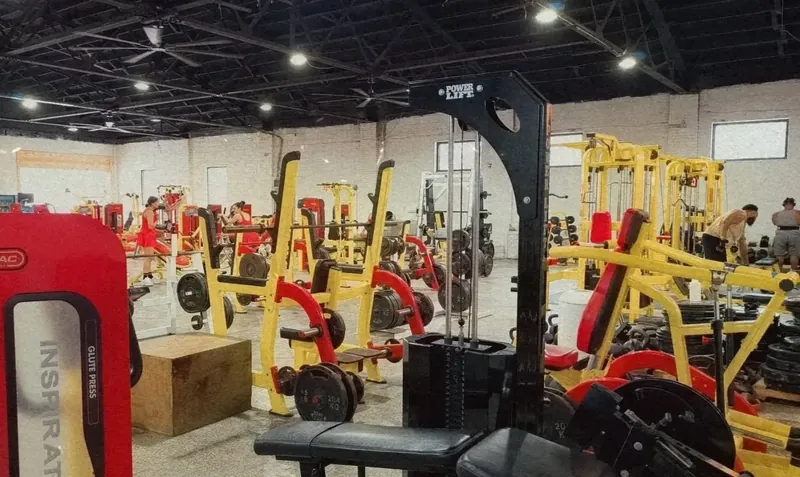 Strength-training area with racks, benches, and weight machines