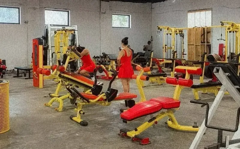 Workout floor with benches and cable machines in use