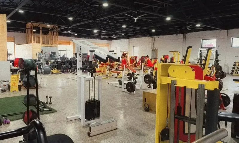 Wide workout floor with strength equipment and open training space